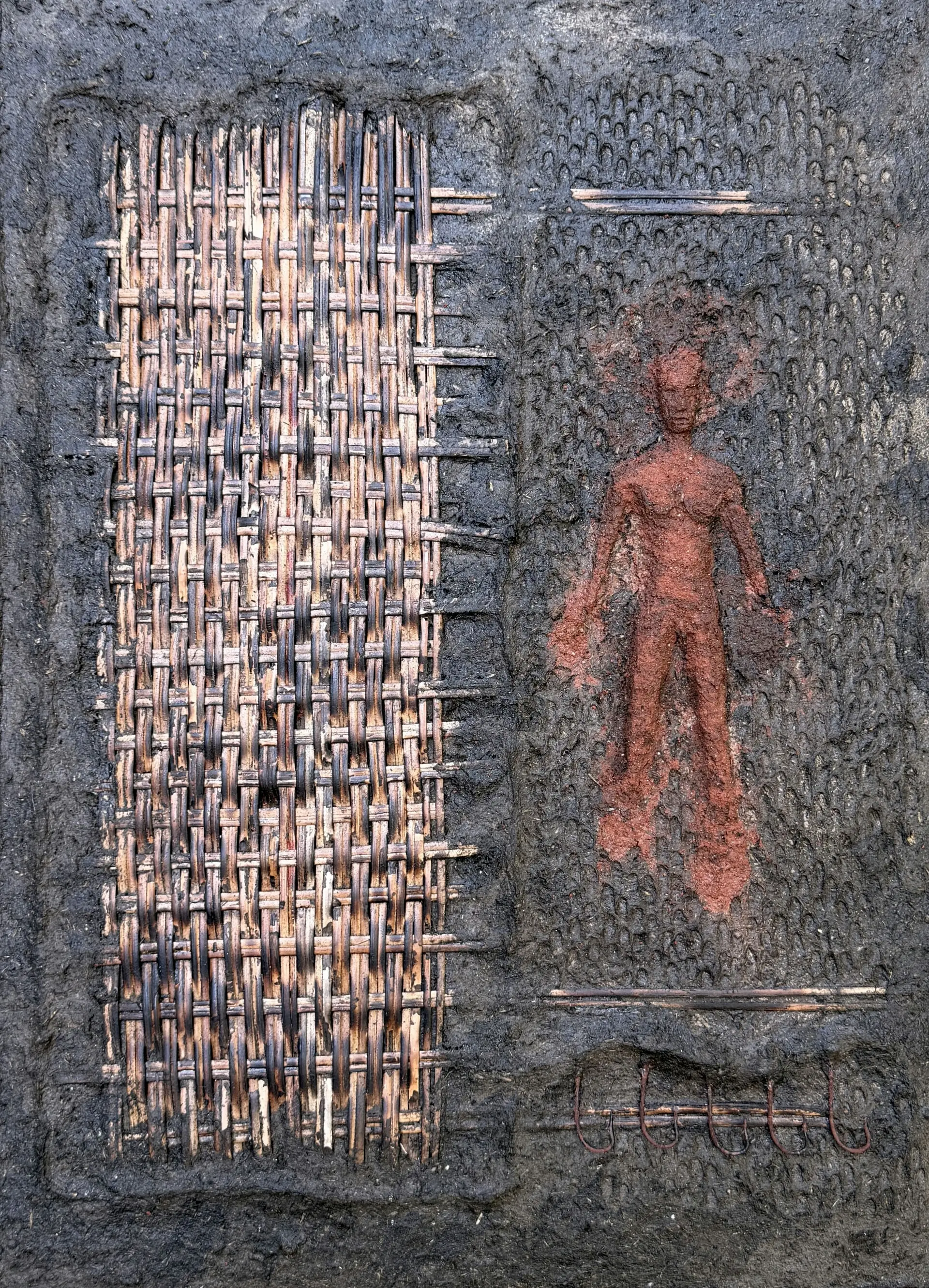The commodification of ground by Manjit Gogoi - Mixed media (cow dung, cane, and fishing hooks on plywood)